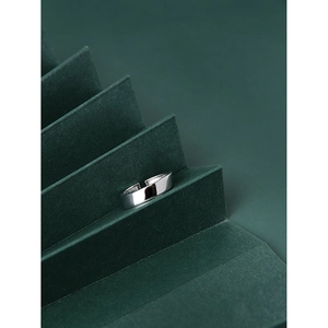 Polished S925 sterling silver minimalist open ring displayed on dark green steps