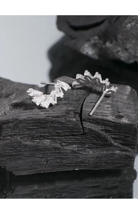 Close-up of S925 sterling silver stud earrings with sparkling baguette cut crystals