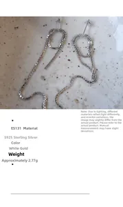 Detail of S925 sterling silver box chain earrings with knotted design on a ceramic plate