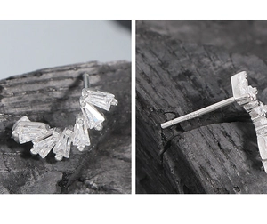 Detail of S925 sterling silver crescent stud earrings with step-cut square zirconia crystals