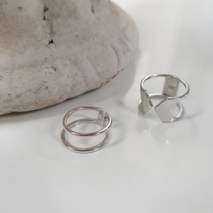Macro detail of S925 sterling silver stamp on minimalist double-layered open ring
