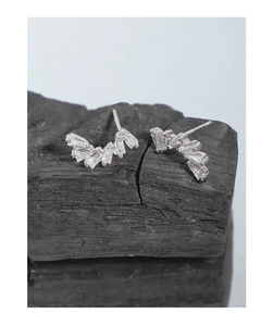 Detail shot of S925 sterling silver baguette-cut cubic zirconia curved stud earrings