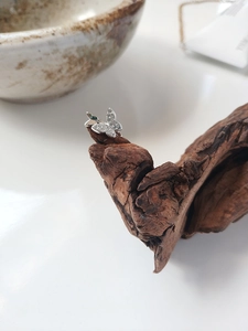 Detailed macro view of S925 sterling silver butterfly clip with sparkling cubic zirconia