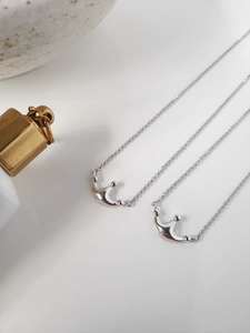 Detailed view of dual S925 sterling silver necklaces featuring elegant crown pendants