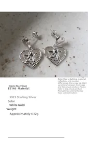 Macro detail of S925 sterling silver heart earrings with Cupid relief on stone background