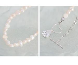 Detail of S925 sterling silver OT clasp with heart ring and teardrop zircon on pearl necklace