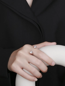 Detail of adjustable S925 silver ring featuring two heart-shaped cubic zirconia stones
