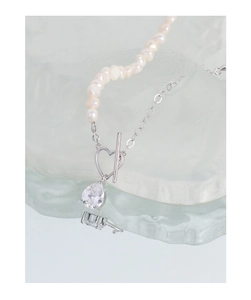 Detailed shot of S925 silver heart OT buckle necklace with pearls and zircon pendant