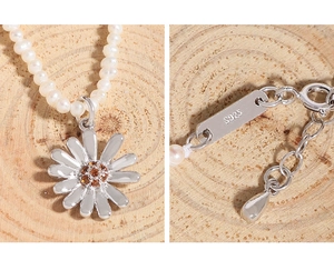 Detail of S925 silver clasp and daisy pendant on natural pearl necklace for women