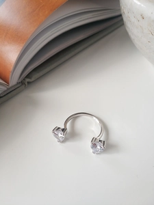 Detail view of S925 sterling silver open ring featuring heart-shaped zircon stones