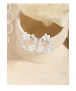 Detailed macro view of S925 sterling silver asymmetrical flower petal stud earrings