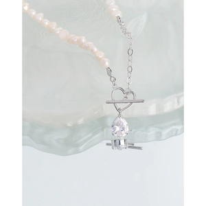 Elegant S925 silver necklace featuring pearls, heart toggle clasp, and zircon drop charm