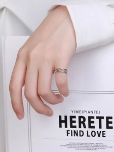 Detail of minimalist double-layered silver ring on finger with elegant geometric design