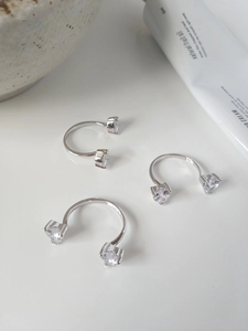 Detail of S925 sterling silver open ring featuring heart-cut cubic zirconia and hallmark