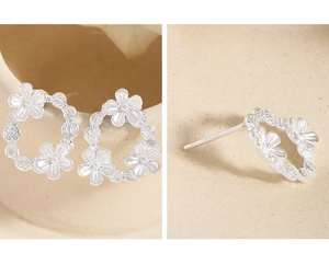Detail of S925 sterling silver floral wreath stud earrings with petal relief and hallmark