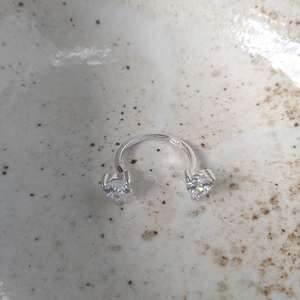 Macro shot of S925 sterling silver stamp on minimalist open ring with heart stones