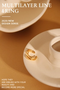 Detailed close-up of multilayered gold open ring on minimalist ceramic holder