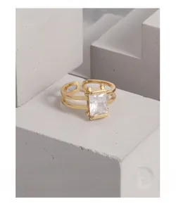 Dettaglio macro dell'anello regolabile a doppio strato dorato con zircone rettangolare grande