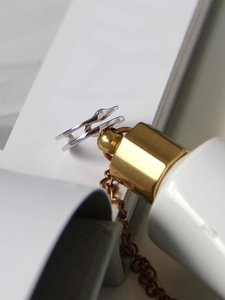 Detailed close-up of S925 sterling silver double-layered wave ring with polished finish