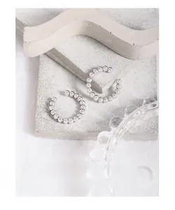 Detail of S925 sterling silver beaded ear cuffs on minimalist stone and wave decor