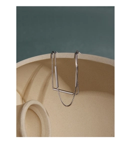 Detail of minimalist S925 silver bracelet with double-layer cylinder pendants