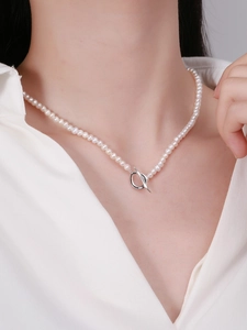 Detail of S925 silver toggle clasp on a minimalist white pearl necklace for women