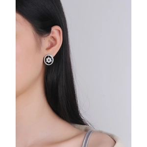 Vintage oval silver earrings with black enamel and pearl flower worn by model