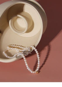 Detail view of S925 silver pearl necklace with OT toggle clasp and gold bead accent
