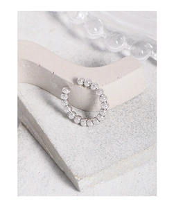 Detailed view of polished S925 sterling silver beaded ear cuff on a minimalist stone base