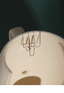 Close-up of minimalist S925 sterling silver double-layer bracelet with geometric bar pendant
