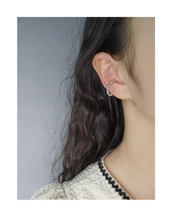 Detail view of silver S925 beaded C-shape ear cuff on model ear for non-pierced ears
