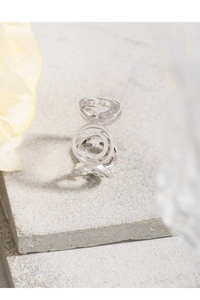 Macro detail of minimalist S925 sterling silver ring with hollow smiley face pattern