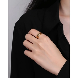 Minimalist multi-layer gold spiral ring in polished finish worn by a model in a suit