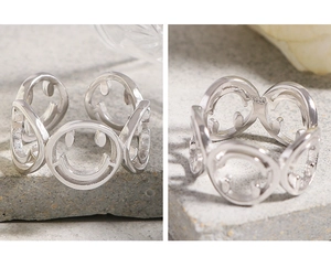 Detail view of S925 sterling silver ring showing hollow smiley faces and inner hallmark
