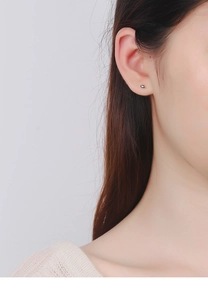 Close-up of minimalist S925 sterling silver bean stud earring worn on model's ear