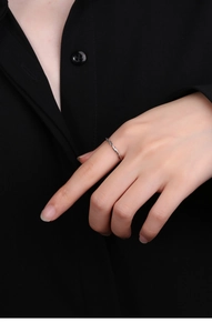 Macro detail of a minimalist S925 sterling silver twisted rope ring worn on finger