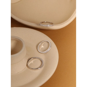 Detailed view of three stackable S925 silver rings with micro-pave cubic zirconia stones