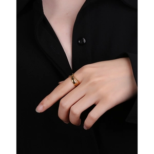 Minimalist S925 sterling silver crisscross ring with polished golden finish worn on hand