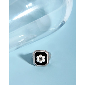 Detailed close-up of retro square S925 silver ring with pearl flower and black enamel