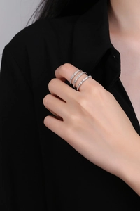 Close-up of stacked S925 sterling silver rings with micro-pave white zircon stones