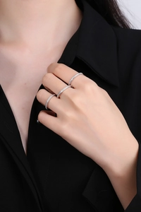 Close-up of three stacked S925 sterling silver rings with zircons on model fingers