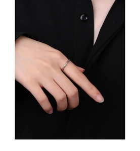 Close-up of minimalist S925 sterling silver twisted rope ring on finger