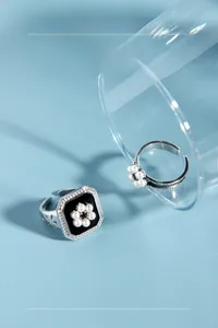 Close-up of S925 sterling silver square ring with black enamel and pearl flower detail