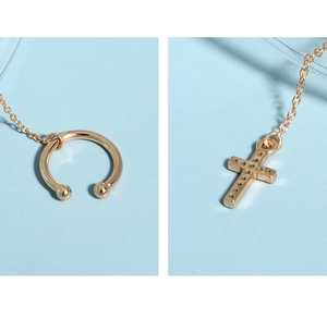 Macro shot of 925 silver cross chain ear cuff with detailed gold plating and embossing