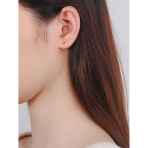 Minimalist S925 sterling silver gold bean stud earrings shown on model ear for daily wear