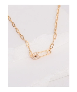 Detail of gold paperclip chain necklace with a zircon-encrusted safety pin pendant