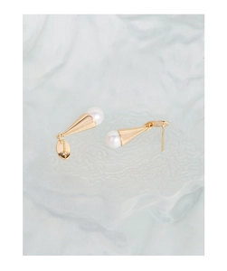 Macro shot of minimalist S925 silver ice cream shaped stud earrings with natural pearls
