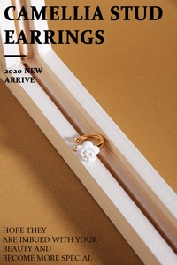 Detail shot of white camellia flower ear cuff with elegant golden metal frame