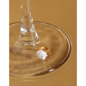 Close-up of a white camellia S925 silver ear clip with elegant gold plating detail