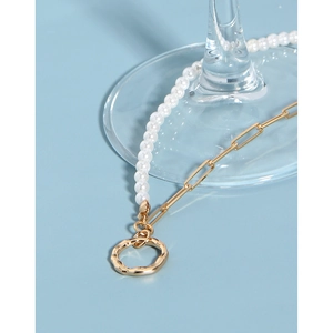 Macro detail of S925 silver necklace with white pearls and gold hammered pendant charm